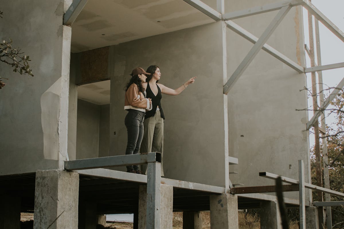 two ladies in a concrete home under construction